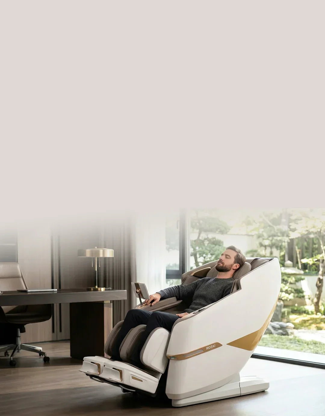 Man relaxing in a luxury full body massage chair in a modern home office setting