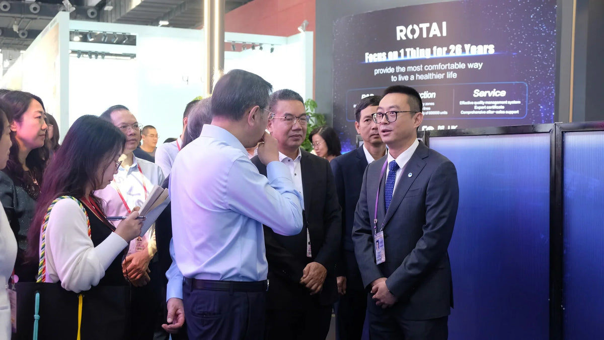 Business professionals networking at ROTAI exhibition booth, trade show event setting